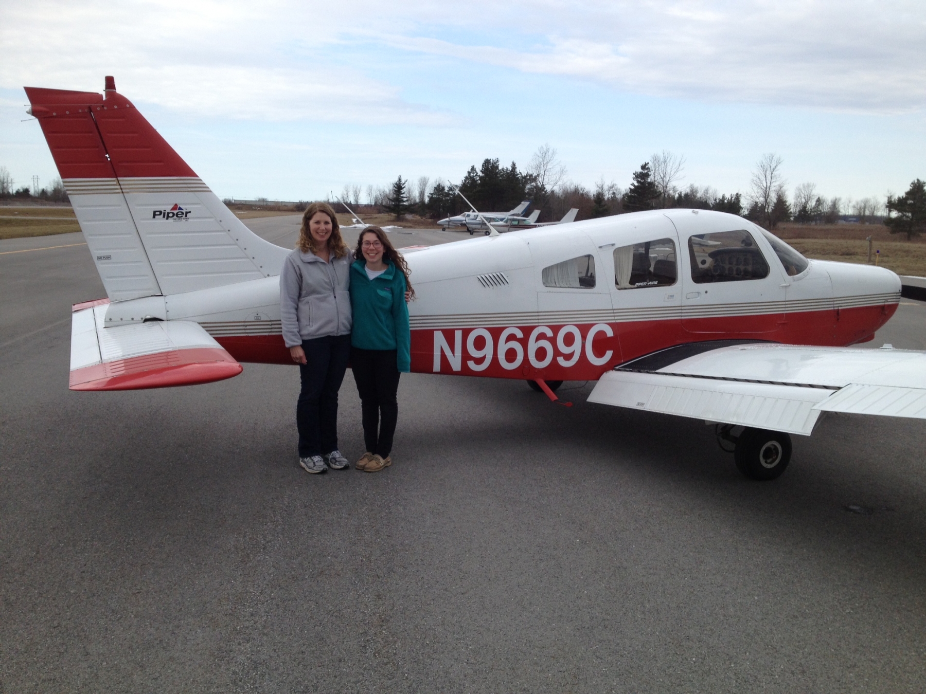 Lisa and her daughter Becky next to airplane Lisa took her flight test in